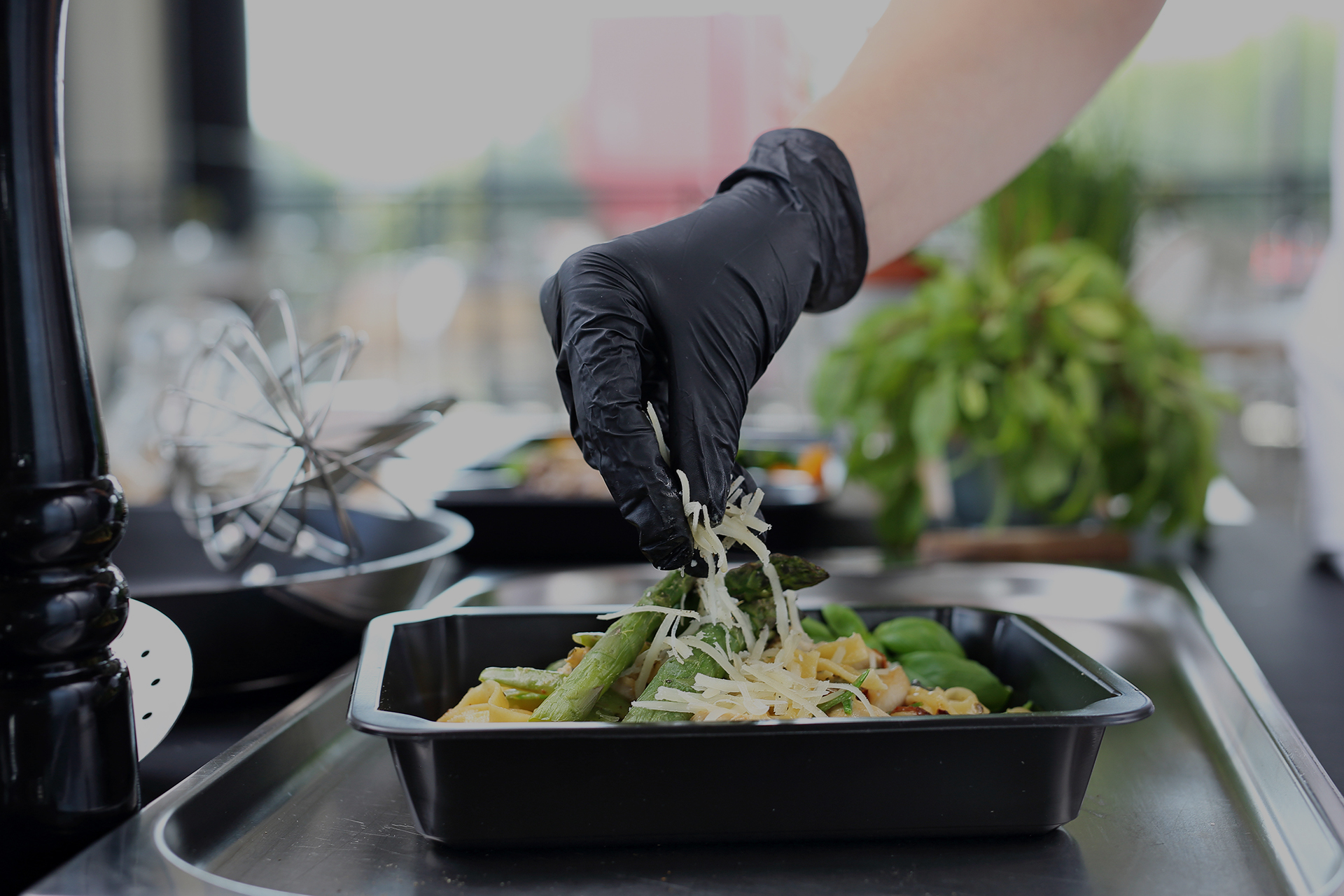 the cook prepares food. pasta with asparagus. take out dish