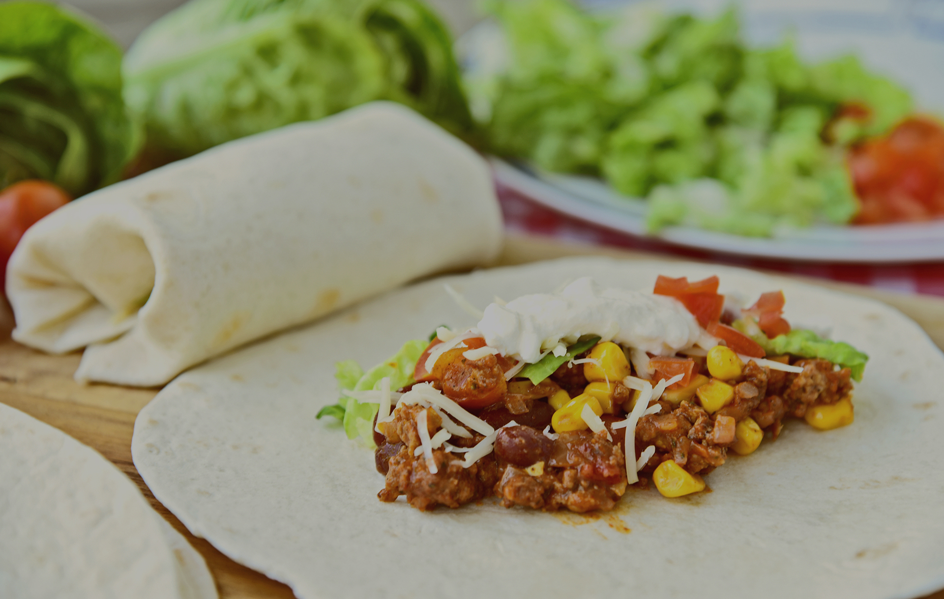 chili con carne burrito with fresh vegetable.